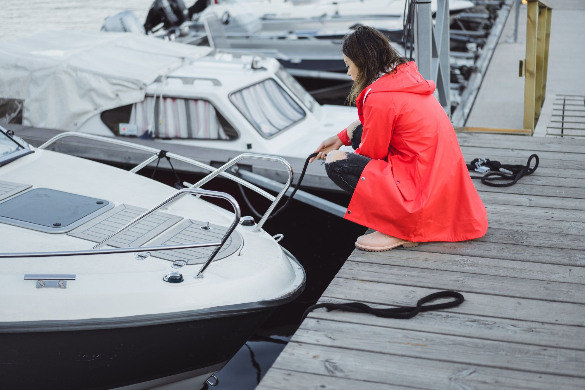 beautiful young woman red cloak yacht port stockholm sweden
